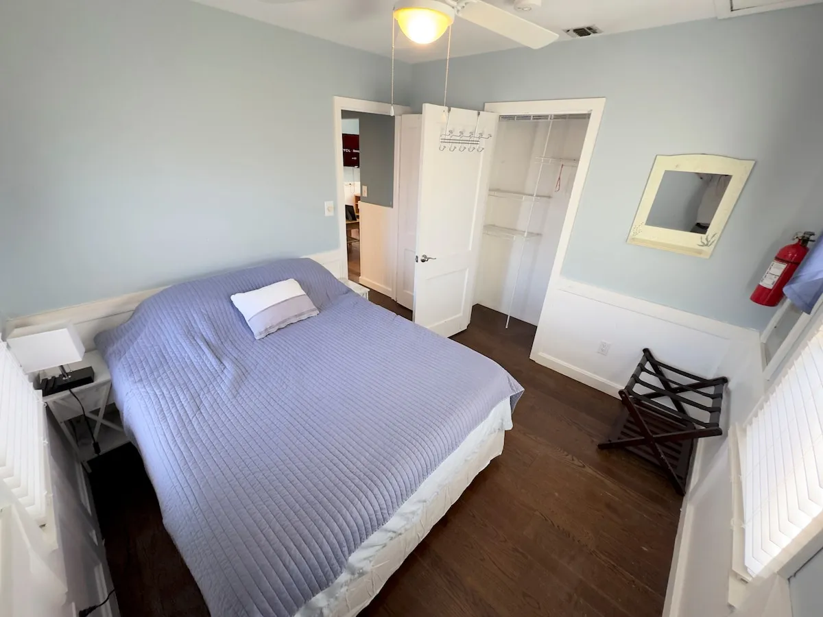 Bedroom 1 with the queen bed and blue-gray walls