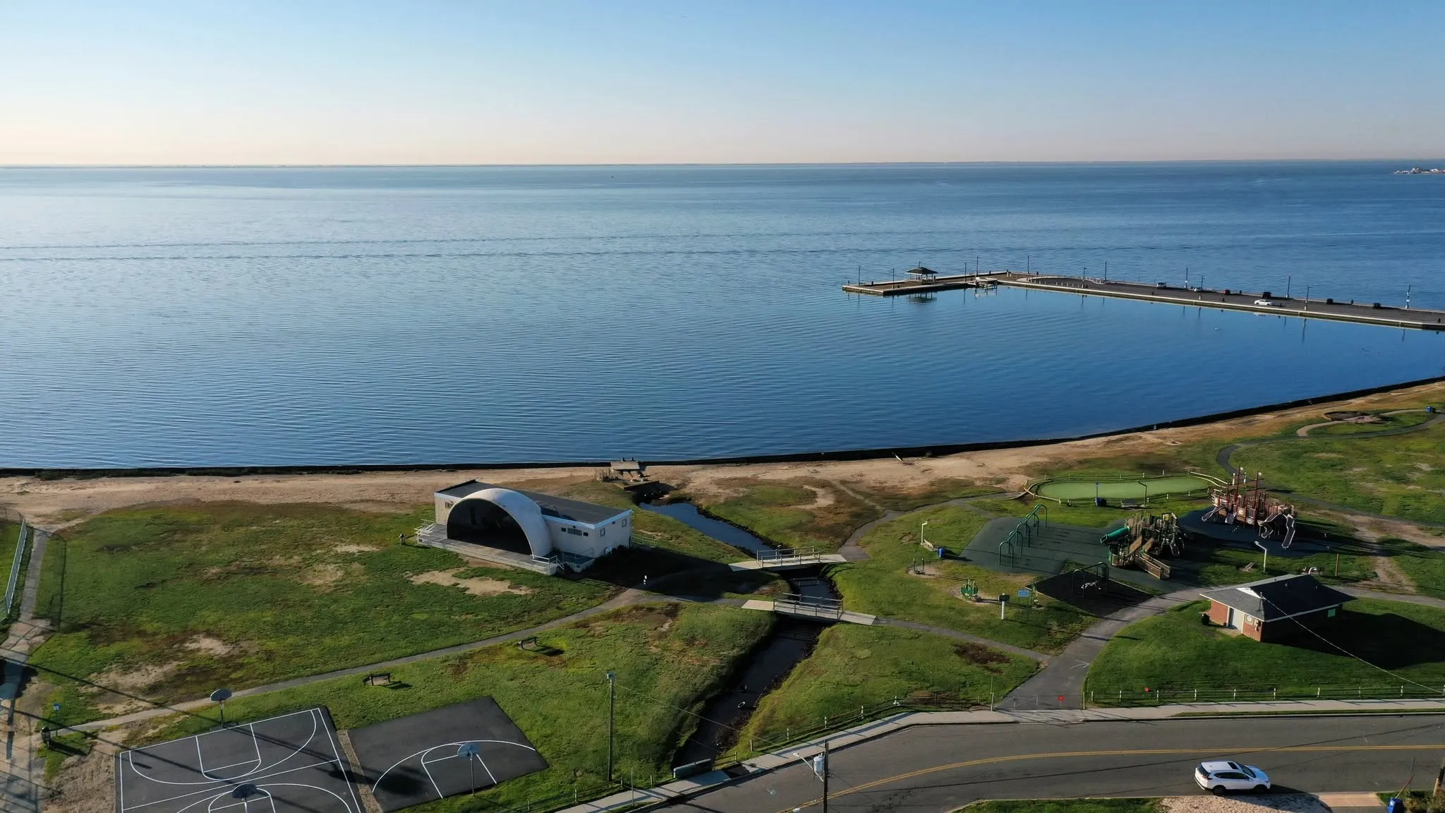 The Great South Bay shoreline at Shorefront Park, seen from above, with the bandshell near the water