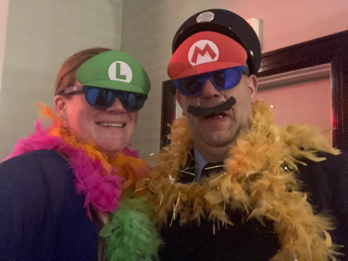 Hosts Natasha and James clowning in Mario and Luigi hats