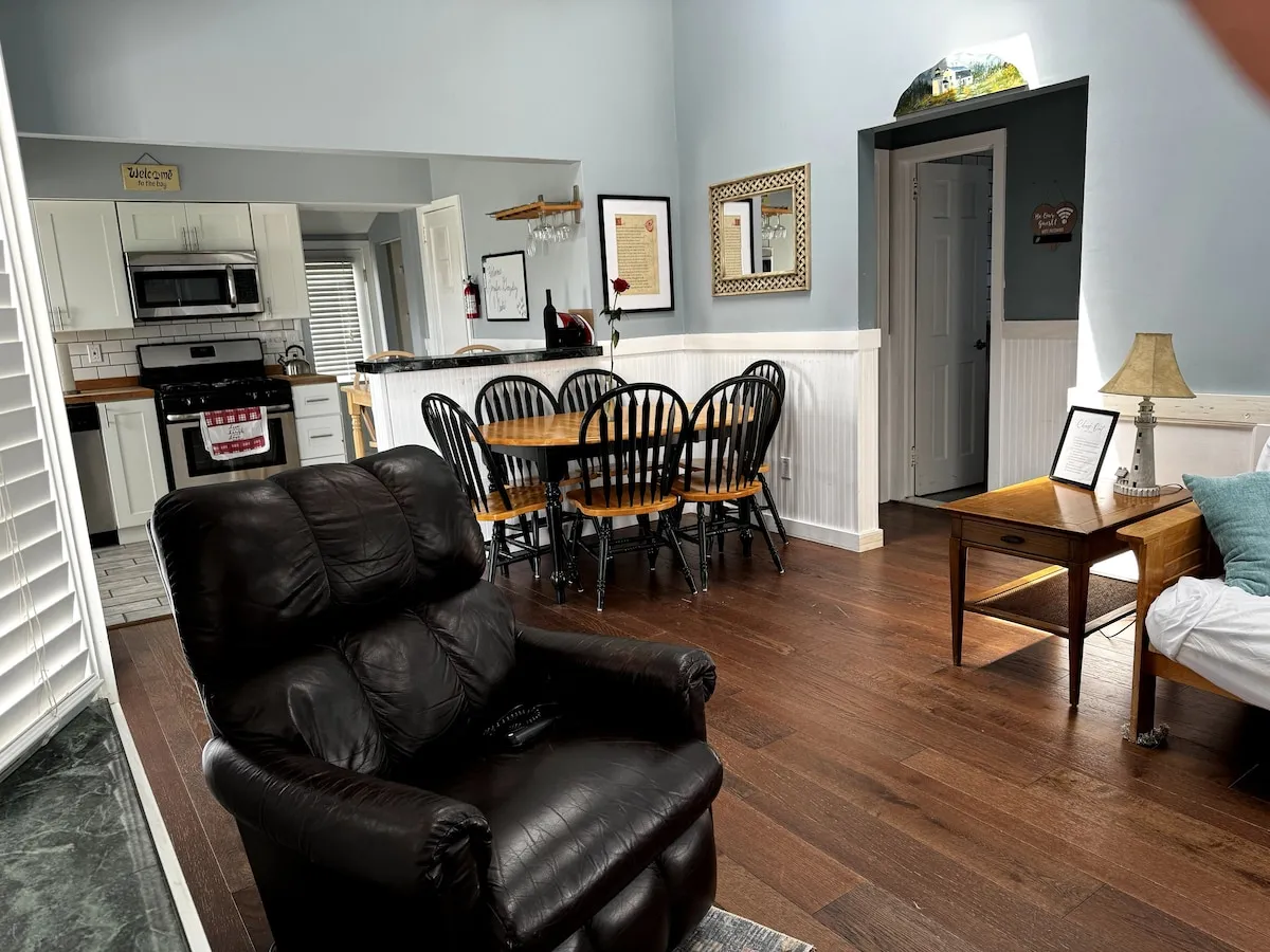 The open-concept living room, with the dining table and kitchen beyond